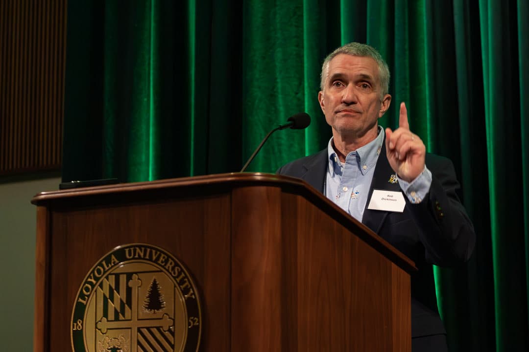 Rob Dickinson '86 giving the welcome from the podium at McGuire Hall