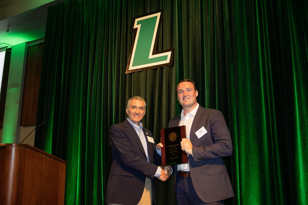 Jimmy Cahill '17 receiving his Hall of Fame plaque