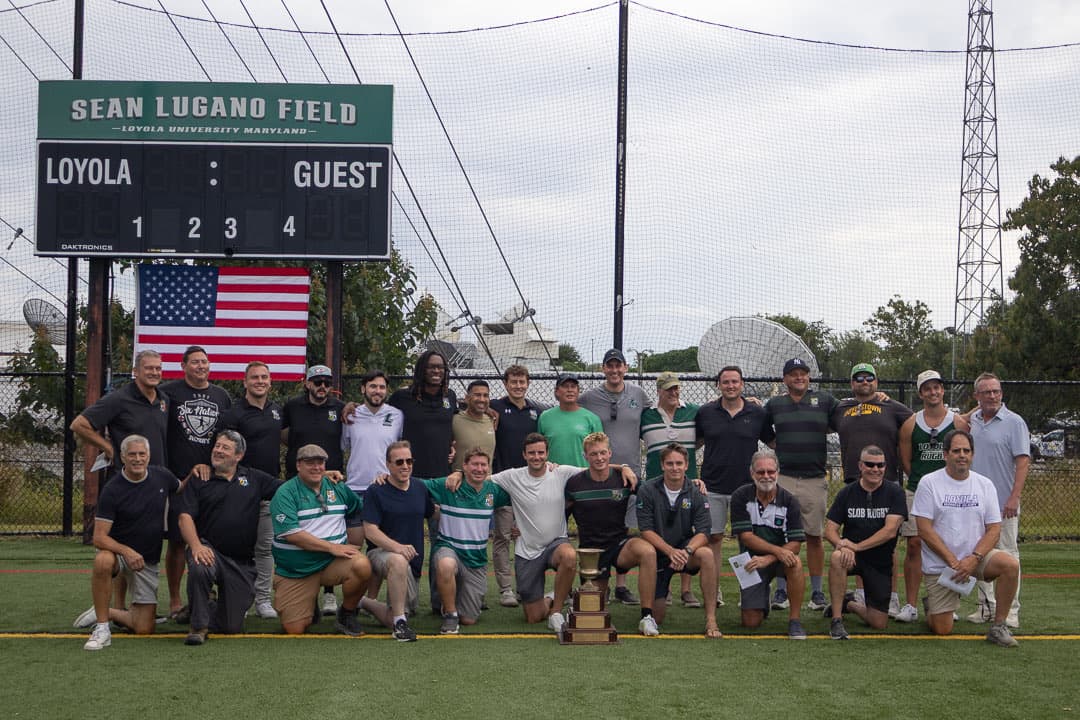 Loc Vetter MVP Award winners from across the decades gathered around the perpetual trophy under the Sean Lugano Field scoreboard