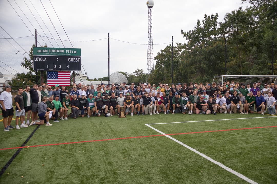 Every alumnus, player and family member at the 50th gathered on Sean Lugano Field beneath the scoreboard for a group photograph